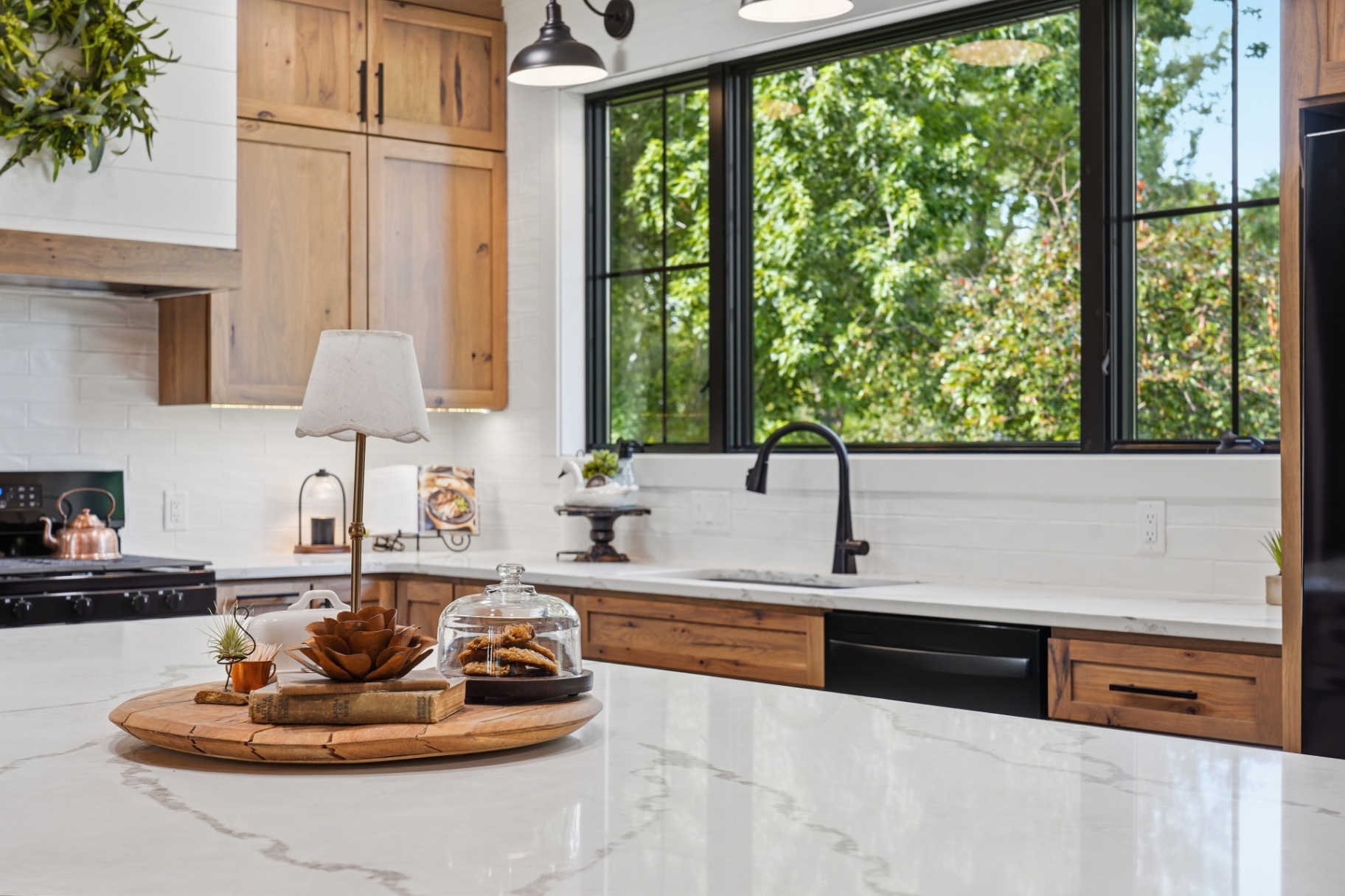 Quartz kitchen island and black framed window in a Gladbrook Iowa renovation