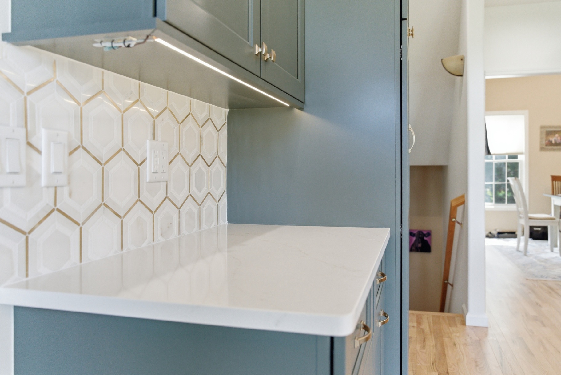 Geometric white tile backsplash with metallic accents in a Waterloo Iowa kitchen