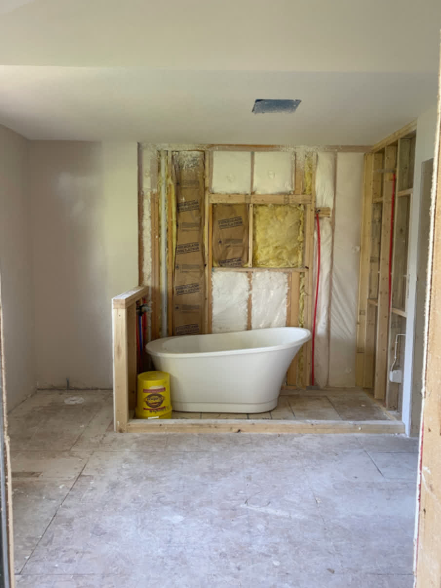 Bathroom under construction with the freestanding tub in place before final finishes