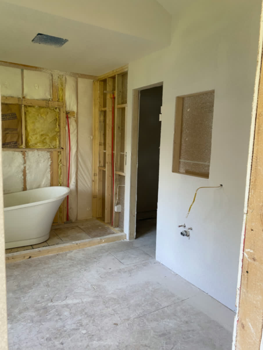 Bathroom remodel in progress with framing changes around the tub area