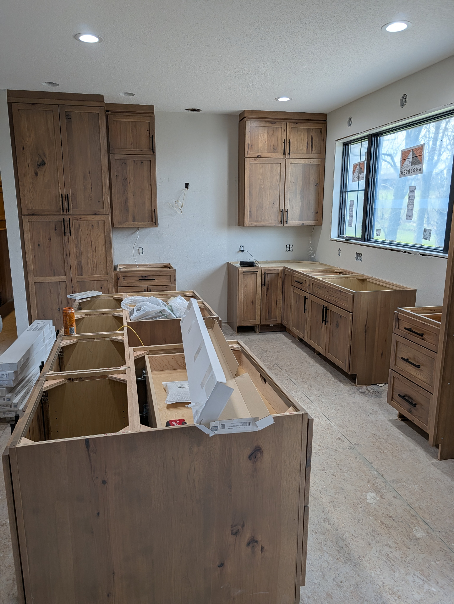 Finished cabinetry along the window wall of the Gladbrook rustic hickory kitchen