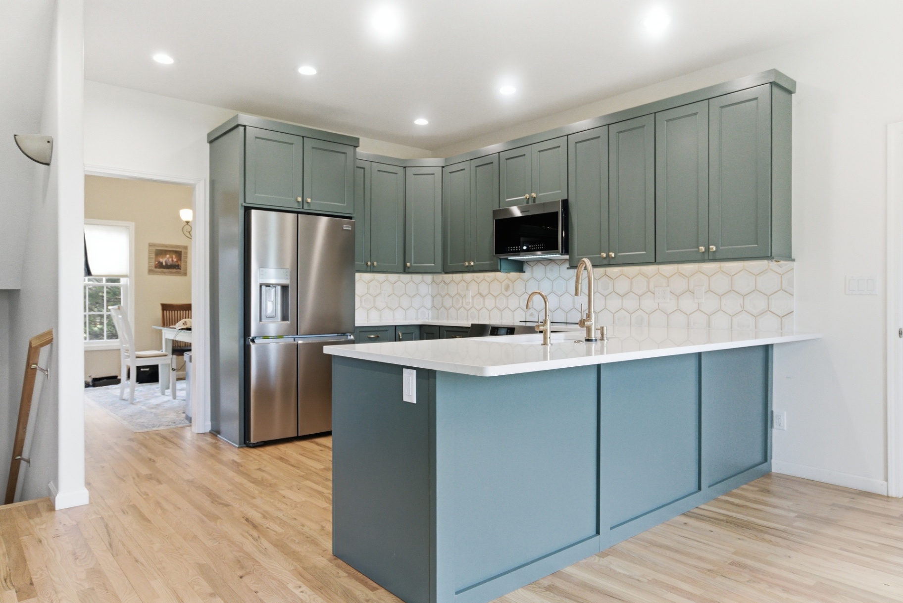 Modern Waterloo kitchen with sage green cabinets and peninsula seating