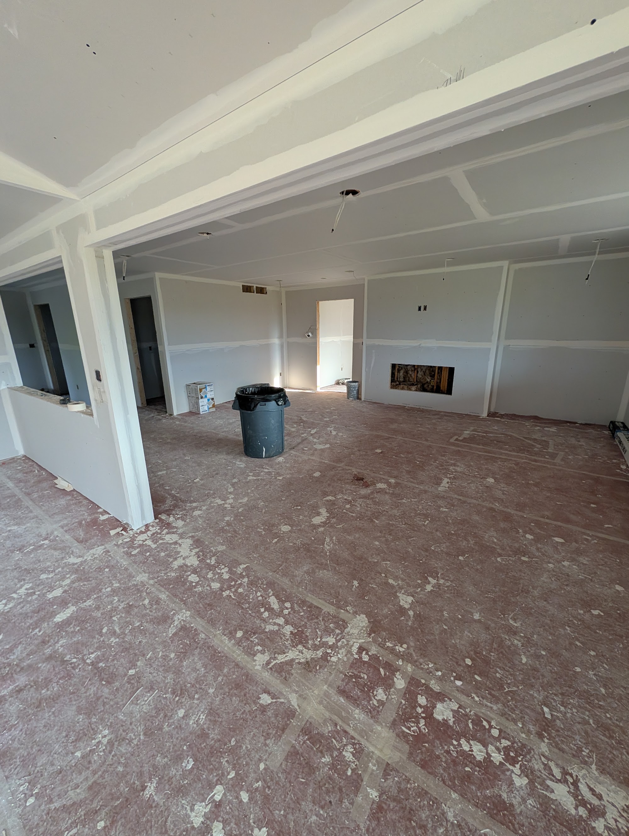 Mid-remodel kitchen torn down to the studs with drywall dust in a Waterloo Iowa home