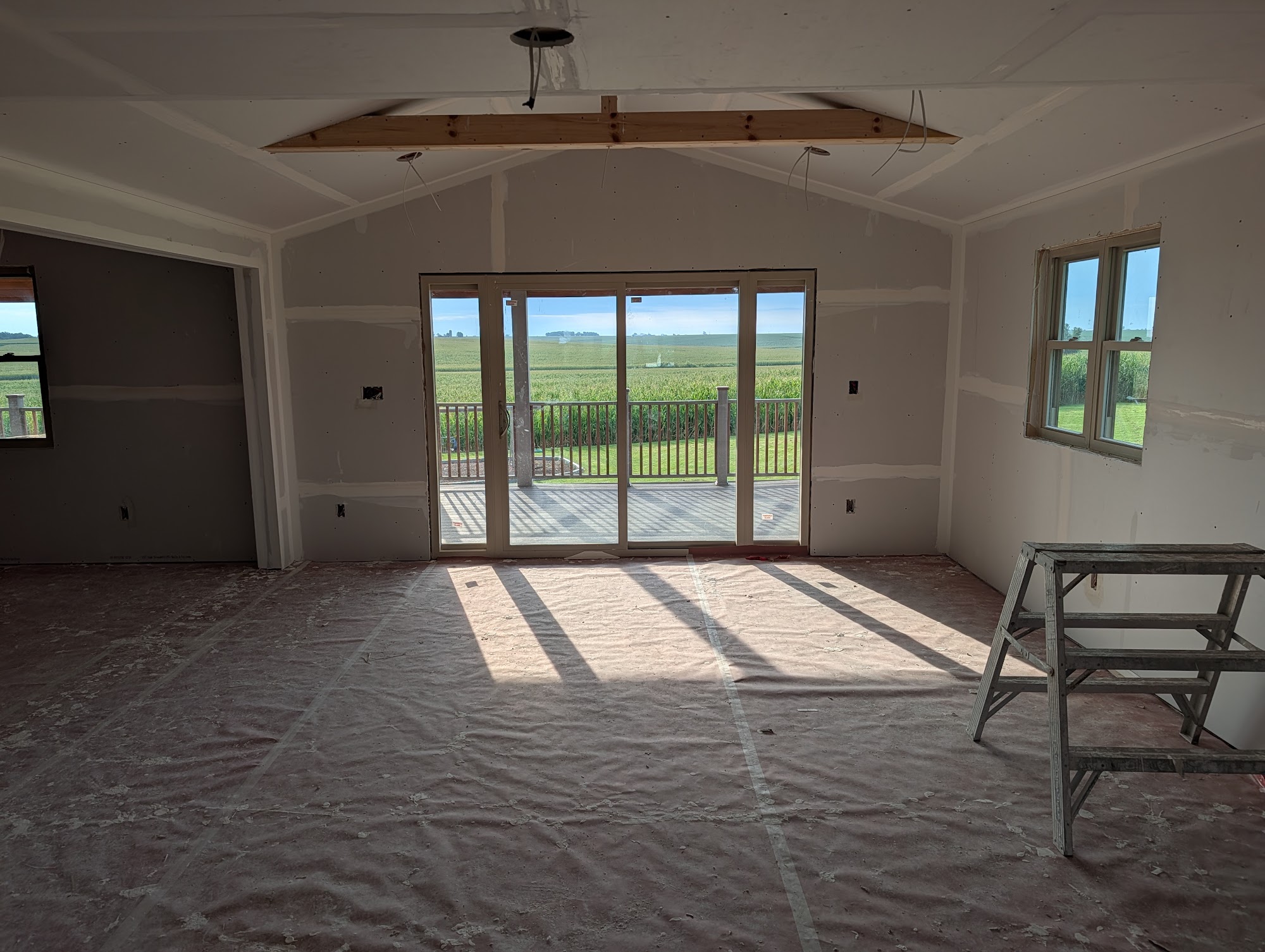 Old flooring being torn out leaving subfloor exposed and covered in dust during a Cedar Falls remodel