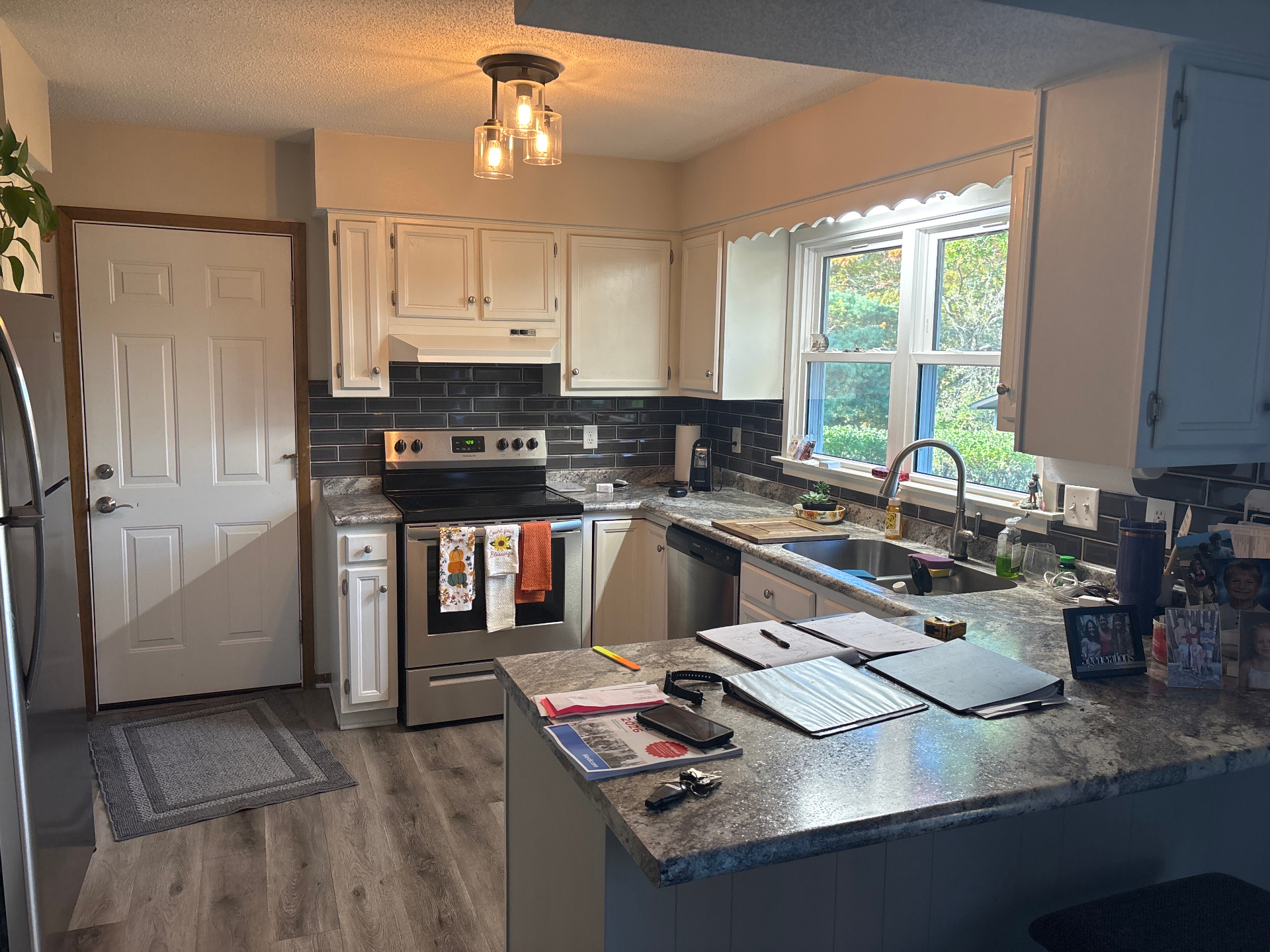 Cedar Falls kitchen before remodel showing dark cabinets and busy countertops