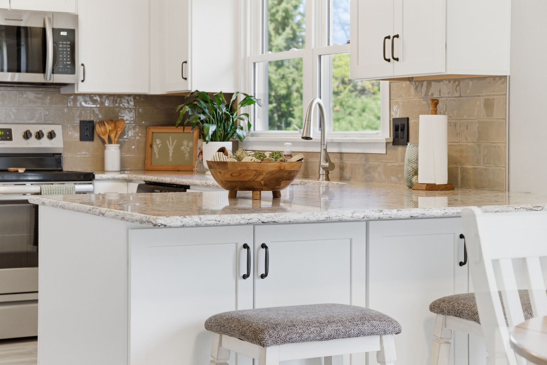 Refreshed white kitchen island with a new quartz countertop in Cedar Falls Iowa