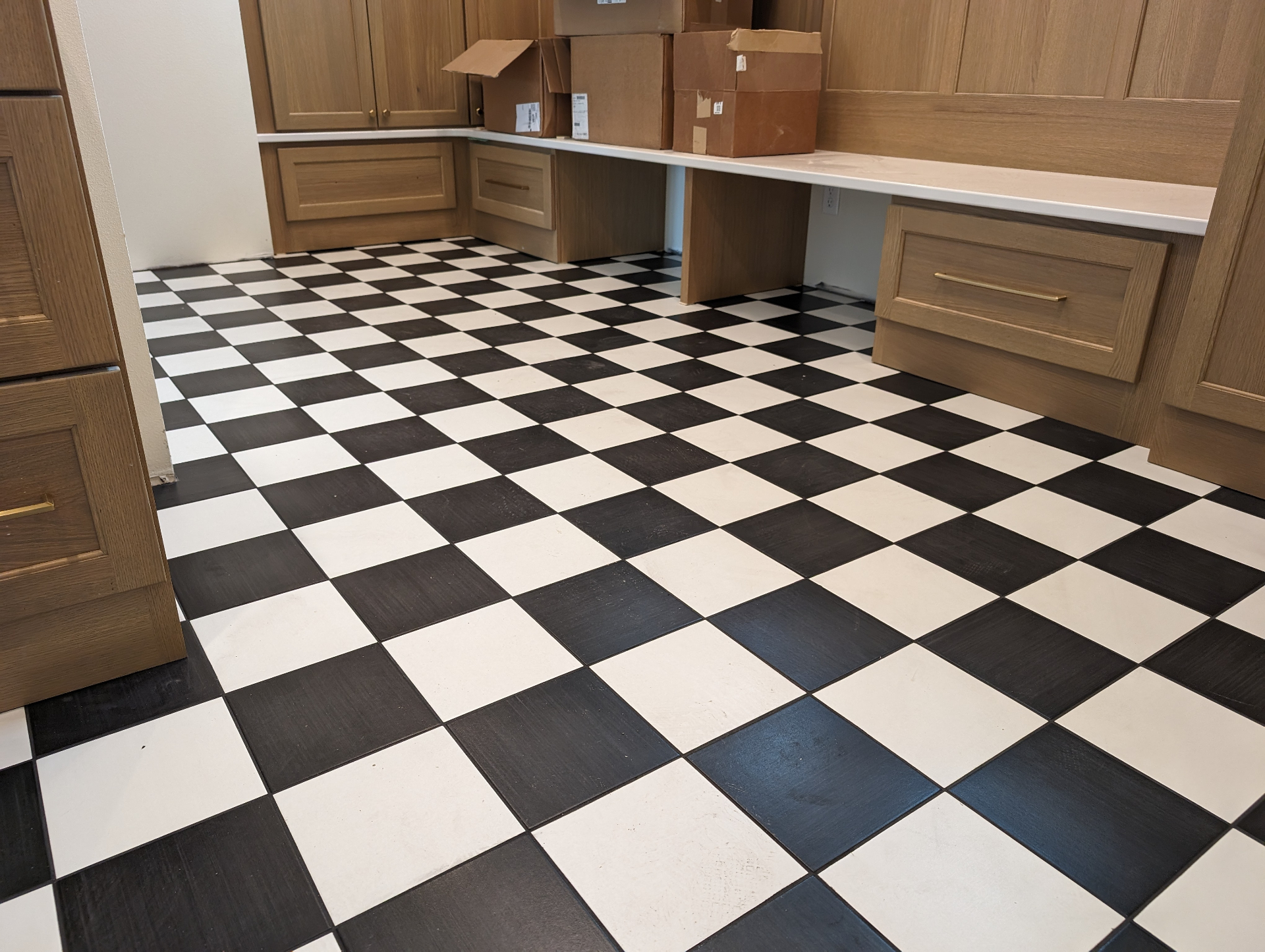 Luxury vinyl plank flooring in a sage green kitchen remodel in Waterloo Iowa