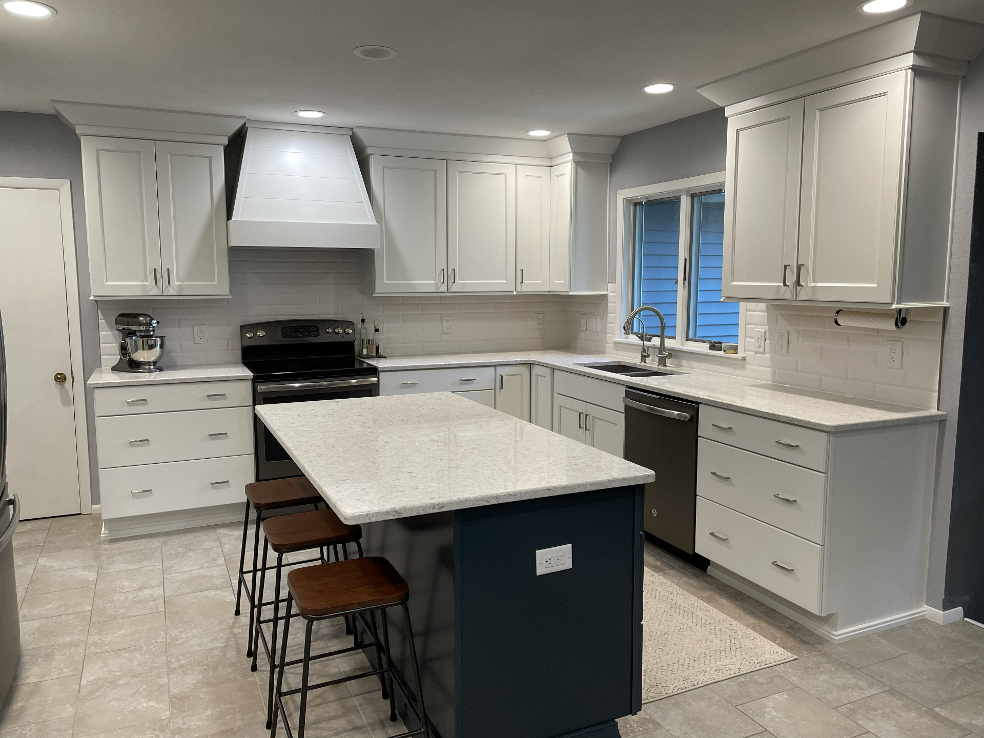 White Kitchen with Navy Island - Kitchen project in Cedar Valley, IA